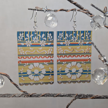Sarape Earrings.  Flower Colorful rectangular floral dangle earrings with blue, yellow, orange, and white decorative patterns.