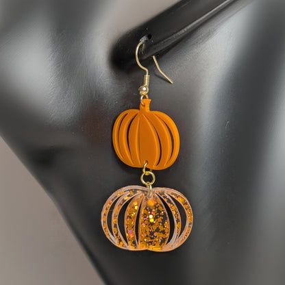 Orange double pumpkin dangle earring with glitter accents, handmade fall and Halloween jewelry.