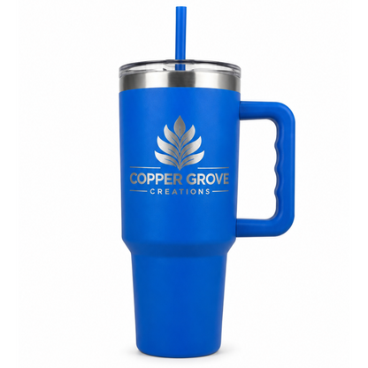 Blue Copper Grove Creations laser engraved insulated tumbler with handle and straw featuring a custom engraved logo design on a clean white background.