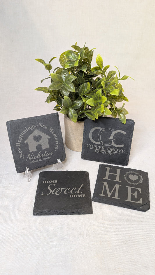 Set of four custom engraved slate coasters by Copper Grove Creations featuring personalized designs and home décor themes, perfect for housewarming gifts and everyday use.