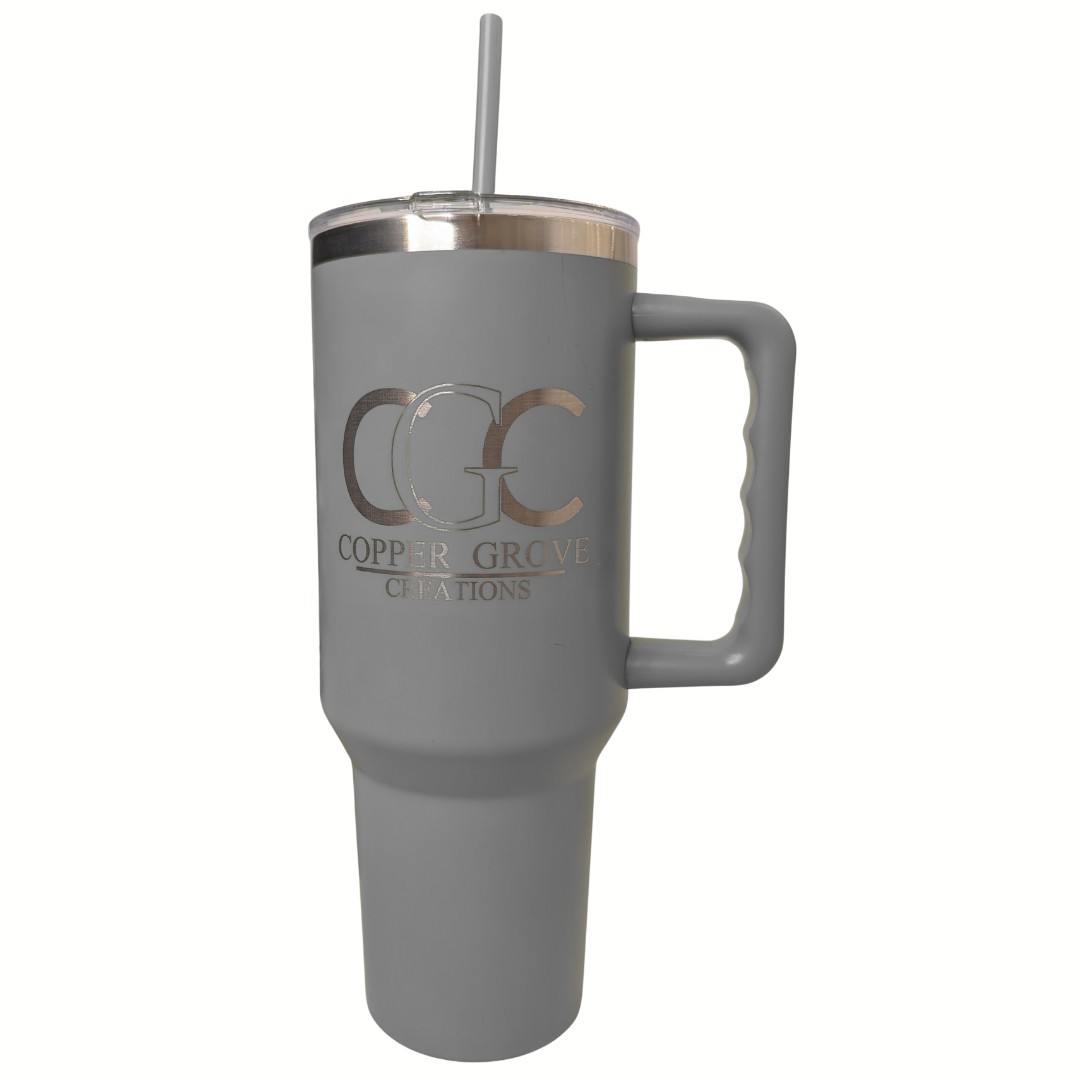 Gray Copper Grove Creations laser engraved insulated tumbler with handle and straw featuring a custom engraved logo design on a clean white background.