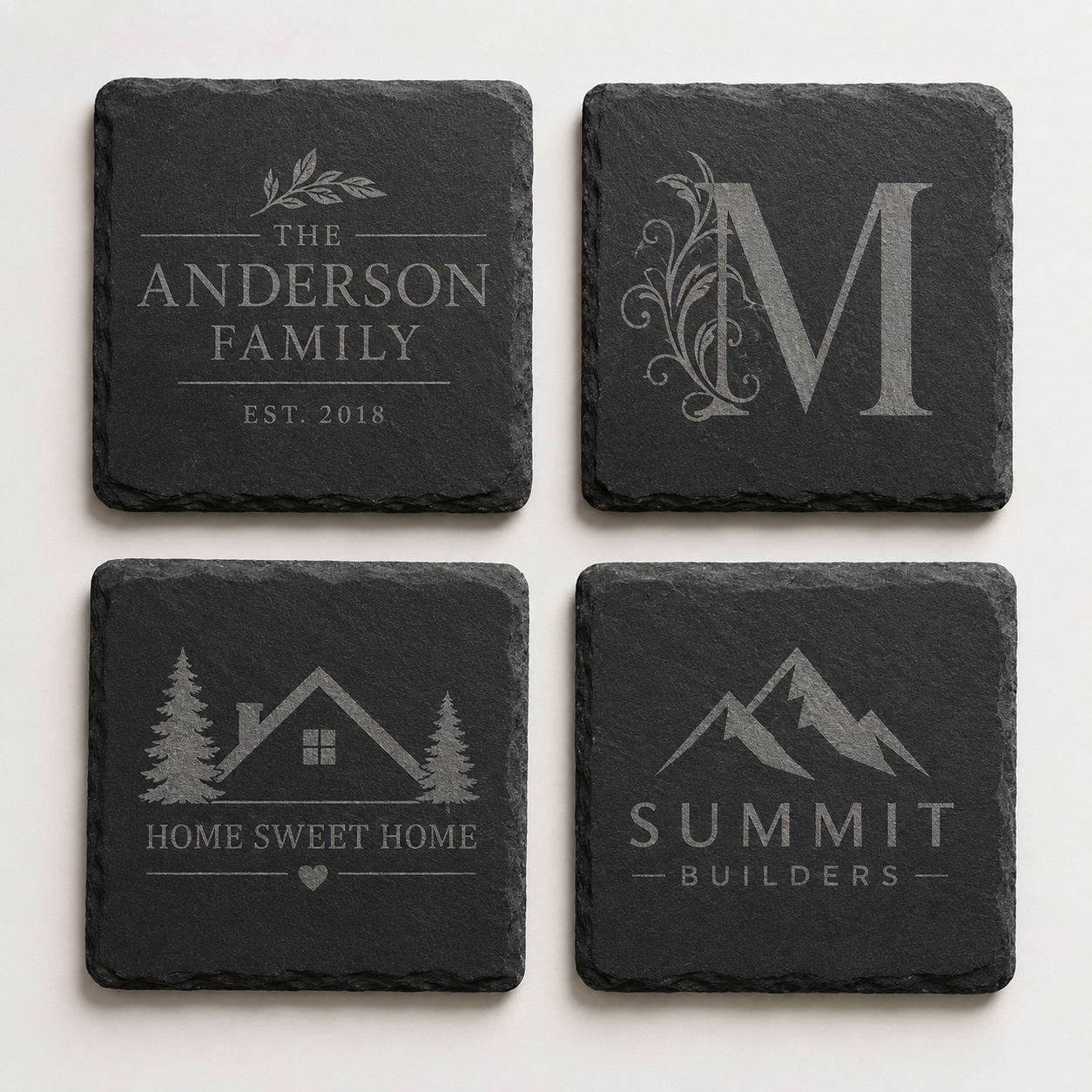 Set of four custom engraved square slate coasters featuring a family name, monogram, home design, and business logo.