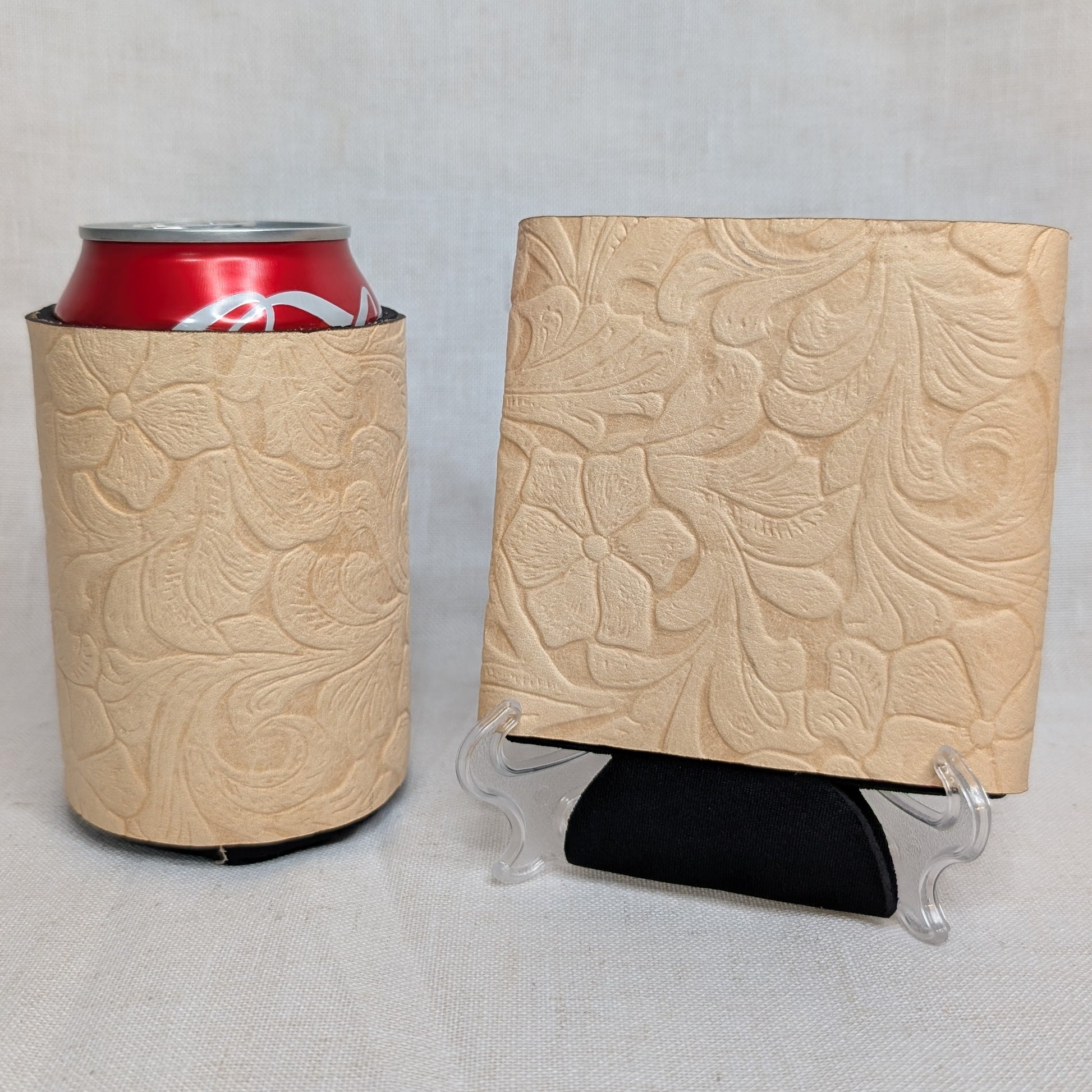 Natural leather can cooler and matching square sample featuring an embossed floral pattern on a light neutral background.