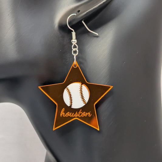 Orange Houston baseball star dangle earring with a white baseball design displayed on a black jewelry stand.