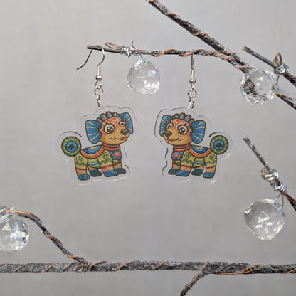 Multicolored dog Alebrije dangle earrings featuring bright Mexican folk art patterns in blue, orange, green, and yellow.