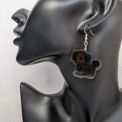 Multicolored dog Alebrije dangle earring with Mexican folk art details displayed on a black jewelry stand.