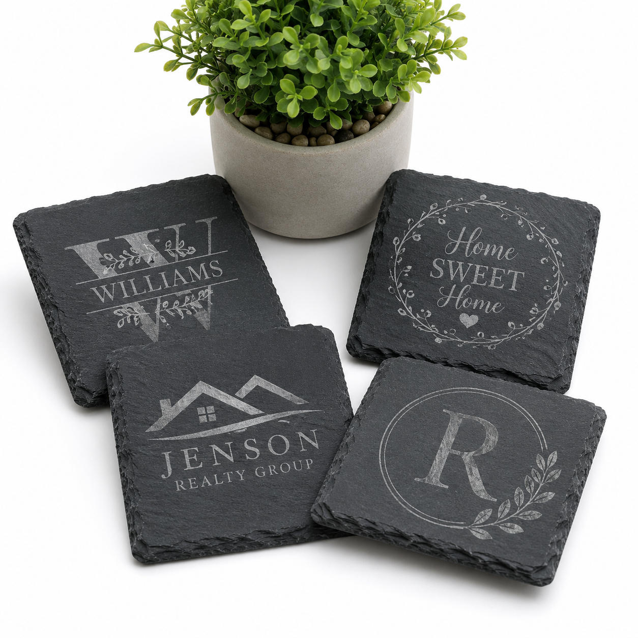 Personalized engraved slate coasters featuring custom family names, realtor logos, monograms, and home designs, handcrafted by Copper Grove Creations.