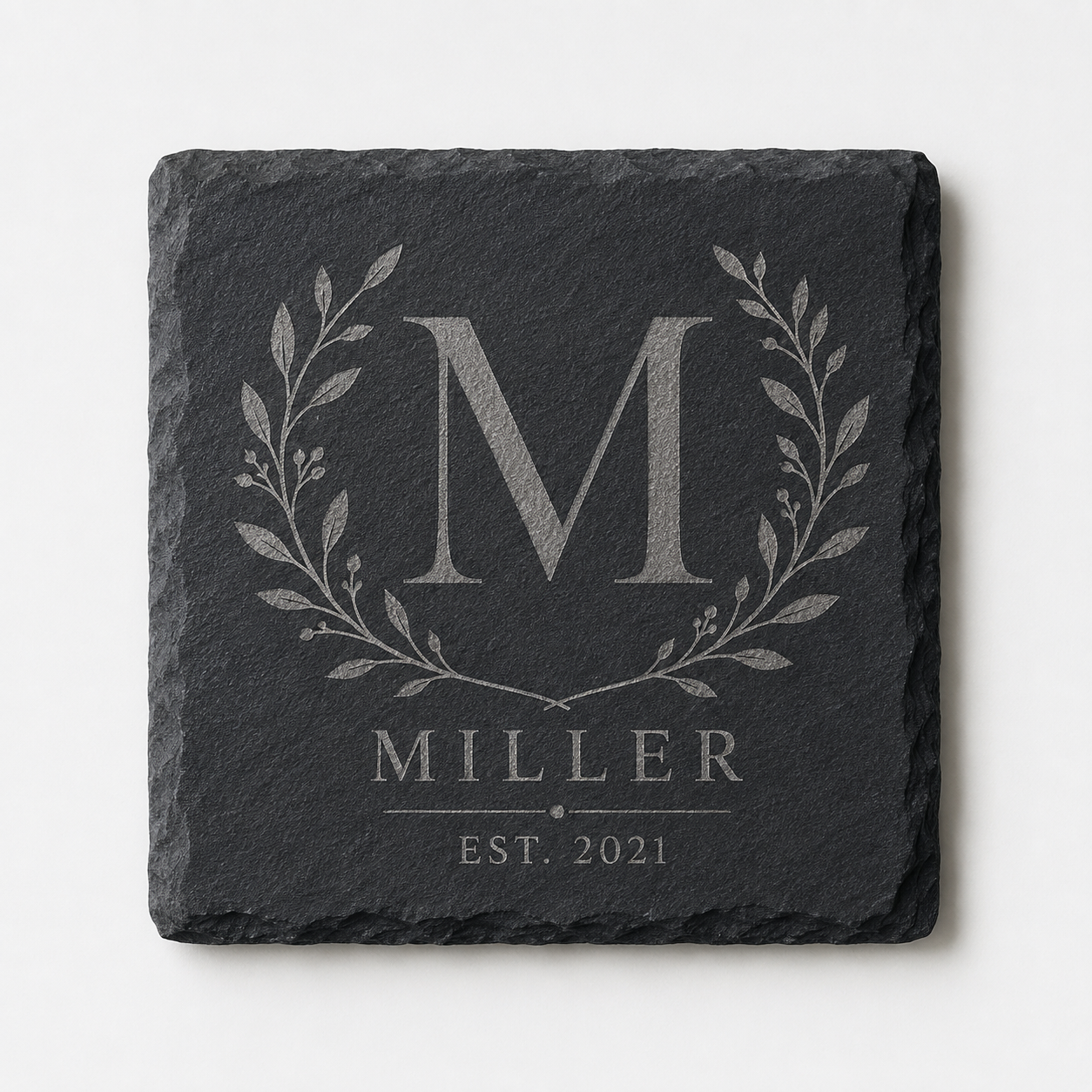 Personalized square slate coaster engraved with a Miller family monogram, botanical wreath, and established date.