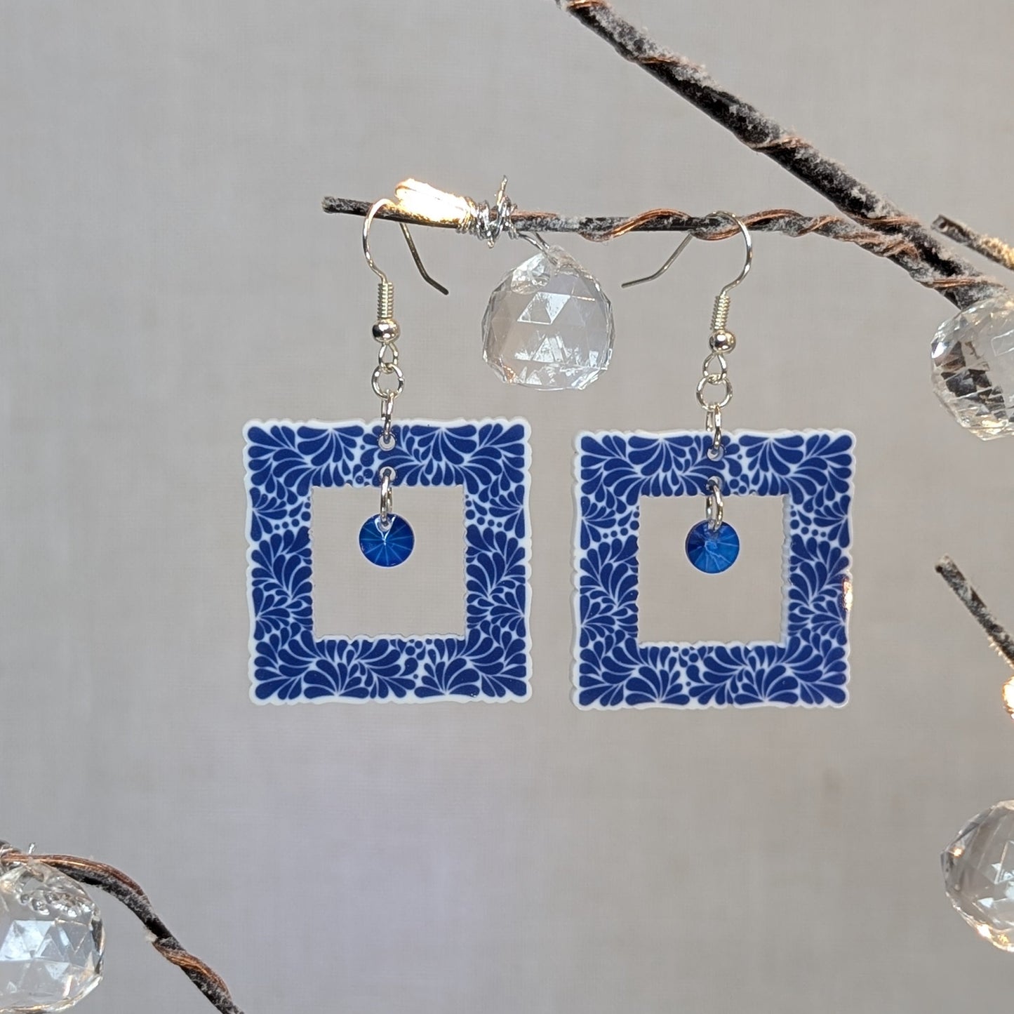 Cobalt blue Talavera square dangle earrings with a white floral pattern and blue center charms.