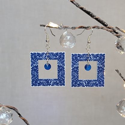 Cobalt blue Talavera square dangle earrings with a white floral pattern and blue center charms.