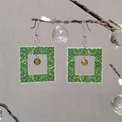 Green Talavera square earrings with white floral patterns and matching green crystal dangle charms.