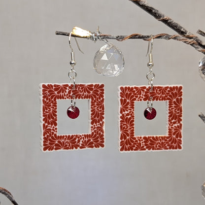 Red Talavera square dangle earrings with white floral patterns and red crystal center charms.