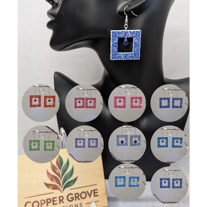 Talavera-style square picture frame earrings shown in multiple color options with a blue earring displayed on a black jewelry stand.