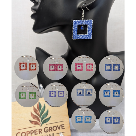 Talavera-style square picture frame earrings shown in multiple color options with a blue earring displayed on a black jewelry stand.
