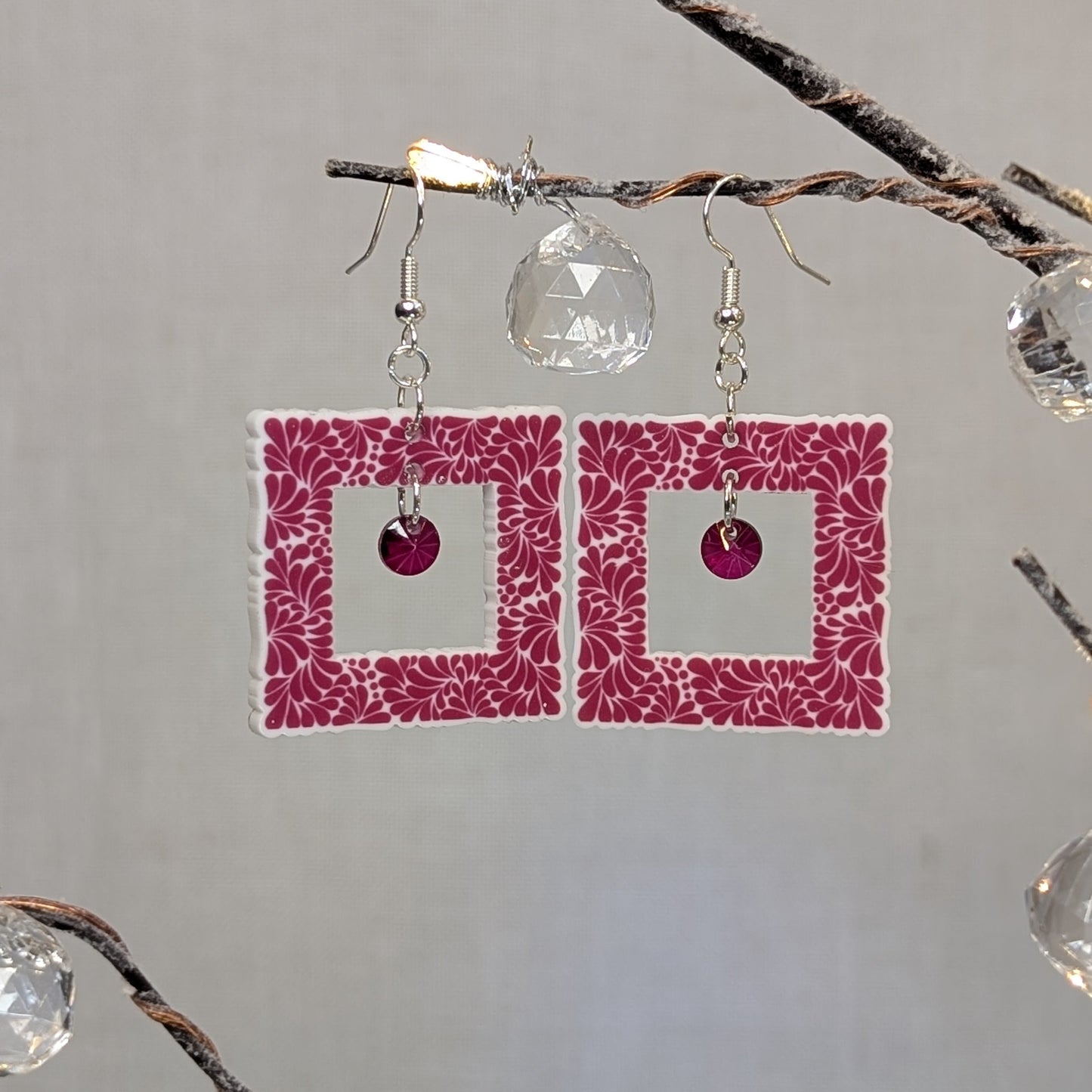 Pink Talavera-style picture frame earrings with white floral patterns and matching pink center charms.