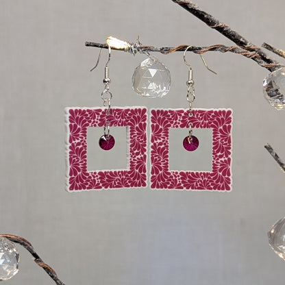 Pink Talavera-style picture frame earrings with white floral patterns and matching pink center charms.