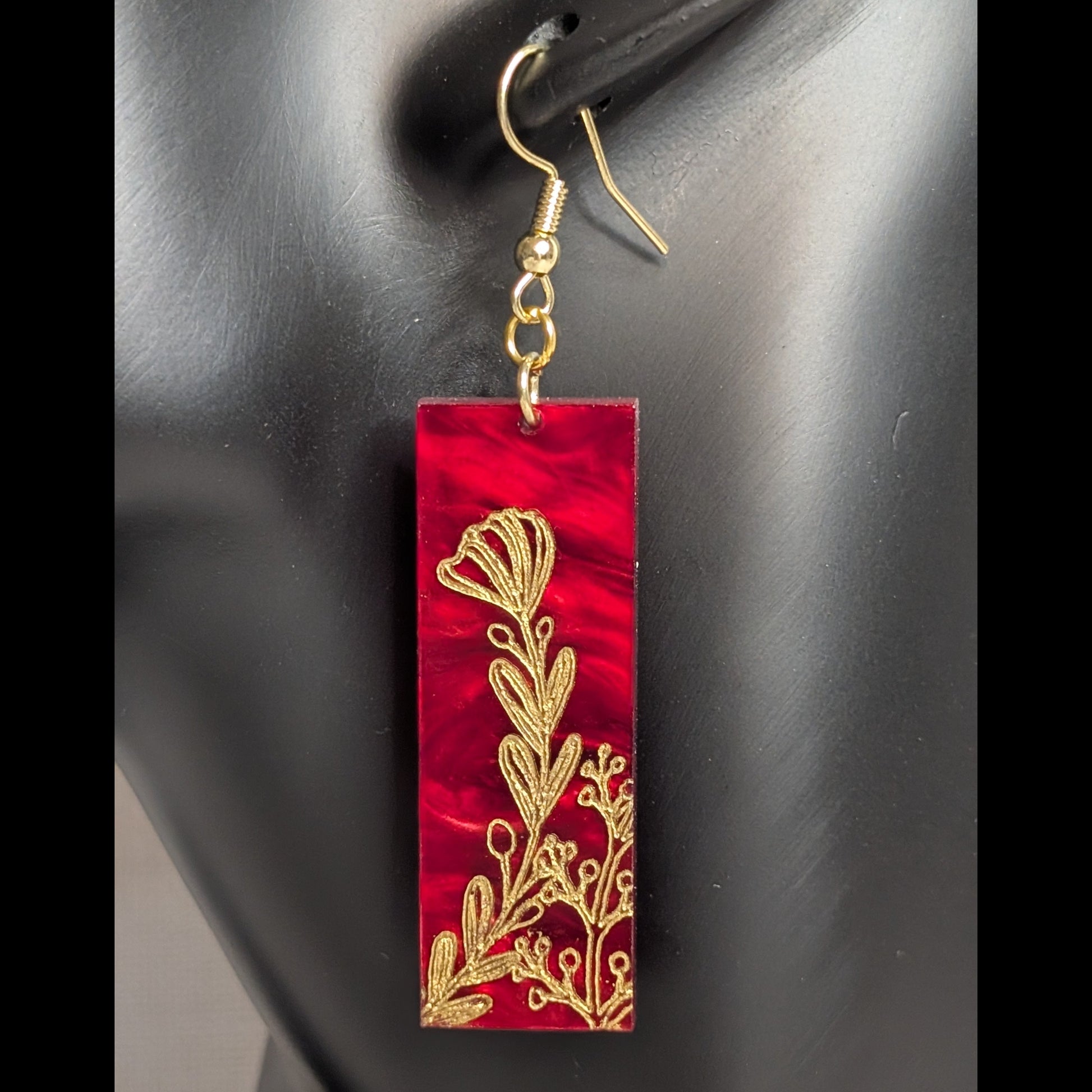 Red rectangular dangle earring from The Gilded Garden Collection featuring an intricate gold floral design.