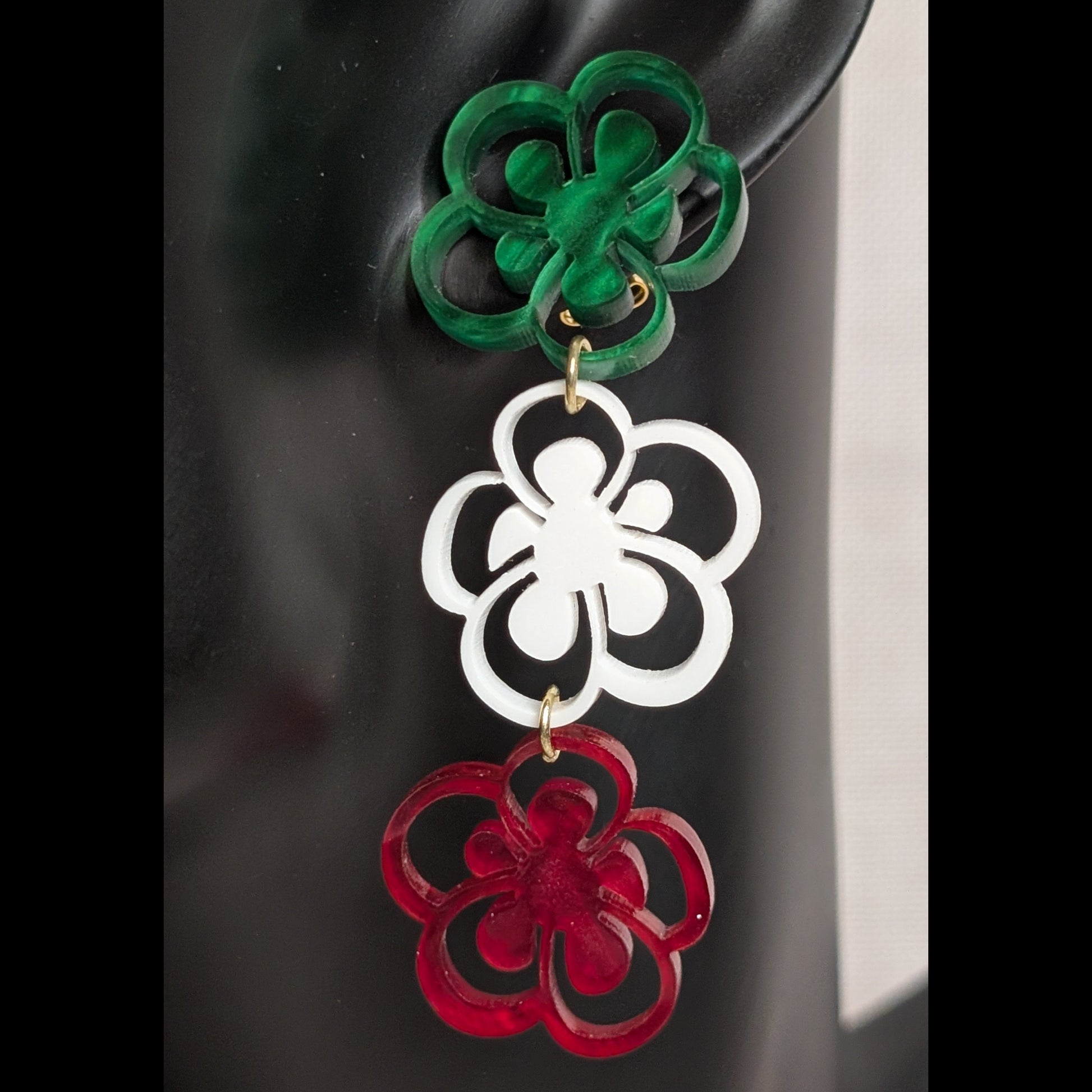 Viva Mexico three-tier floral earrings in green, white, and red acrylic with layered flower shapes.